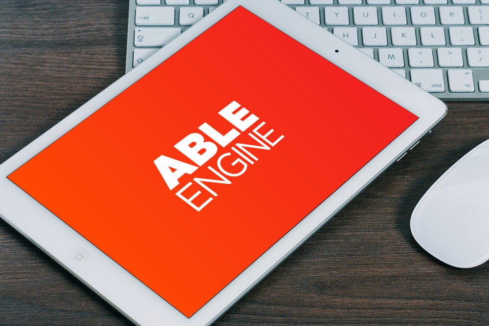 Able Engine logo on a mobile tablet on a desk